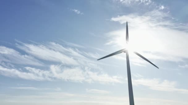 Větrné turbíny rotující proti zářícímu slunci — Stock video