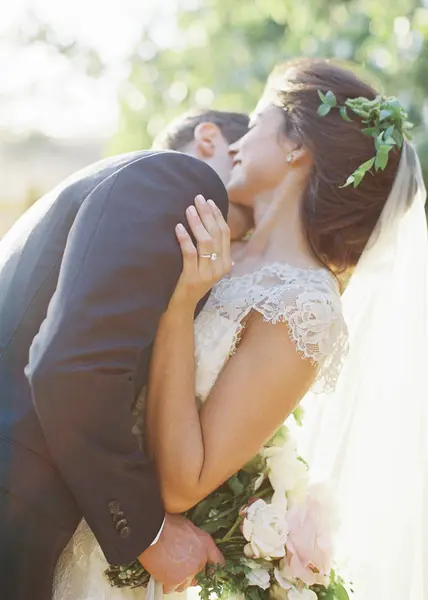 Groom hugging bride — Stock Photo, Image