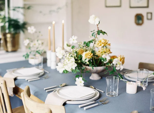 Setting table decorated with flowers — Stock Photo