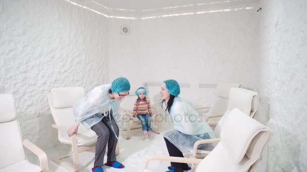 Two women and girl relaxing in a salt cave — Stock Video