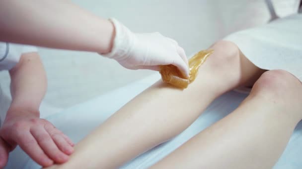 Beautician depilación femenina pierna en spa de belleza — Vídeo de stock