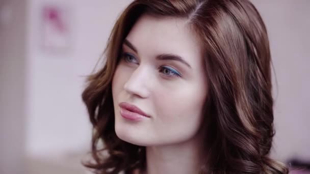 Schöne brünette Mädchen posiert und berührt ihr schönes Haar — Stockvideo