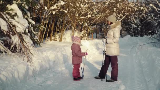 Mutter und Tochter sprechen vor dem Nordic Walking im Winter in der Vorstadt. — Stockvideo