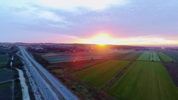 Cars traffic on highway at sunset. Aerial view. Beautiful landscape. — Stock Video