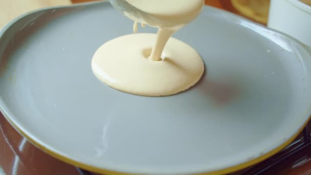 Steel ladle scoop pours the batter on gray hot pan. Home cooking, baking. Slowmo — Stock Video