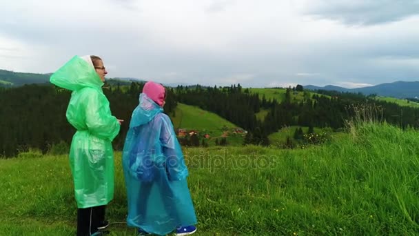 Moeder en dochter in regenjassen — Stockvideo