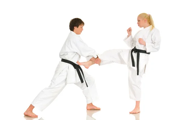 Cute blonde girl and a young cheeky guy karate — Stock Photo, Image