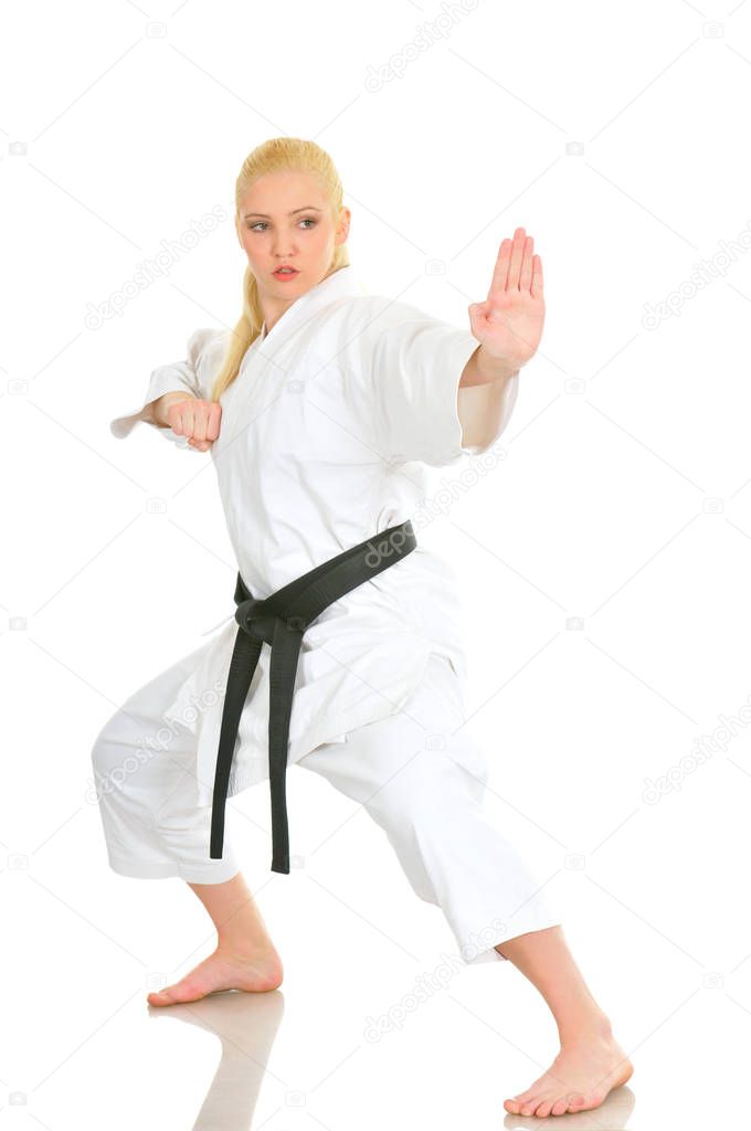 Girl blonde karate sportswoman in a kimono