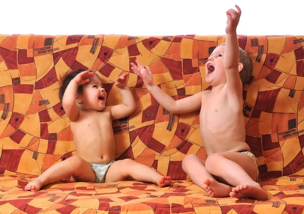 Bambini che ridono seduti sul divano e la gioia — Foto Stock