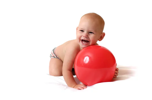 Small plump baby paly the red toy ball — Stock Photo, Image