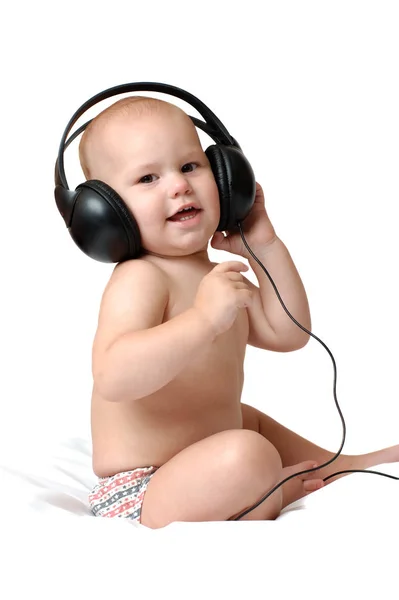Baby listen real music in headphones play, he try danse. Stock Image