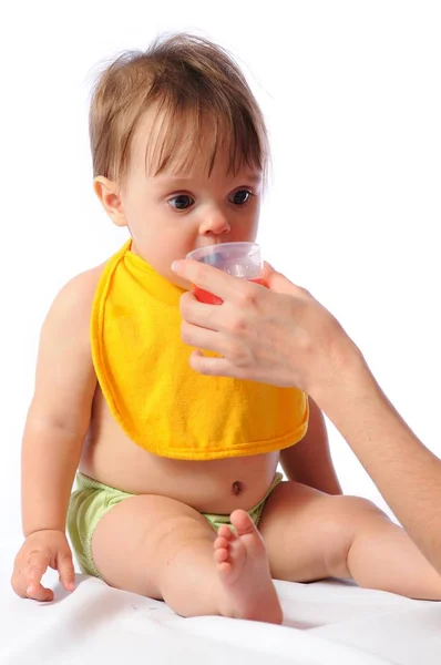 Little baby drinks water from cup — Stock Photo, Image