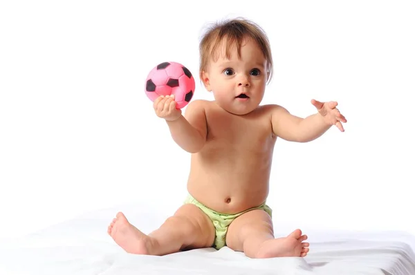 Little baby plays with small football ball — Stock Photo, Image