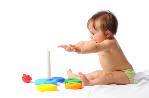 Surprised funny baby playing with toy — Stock Photo, Image