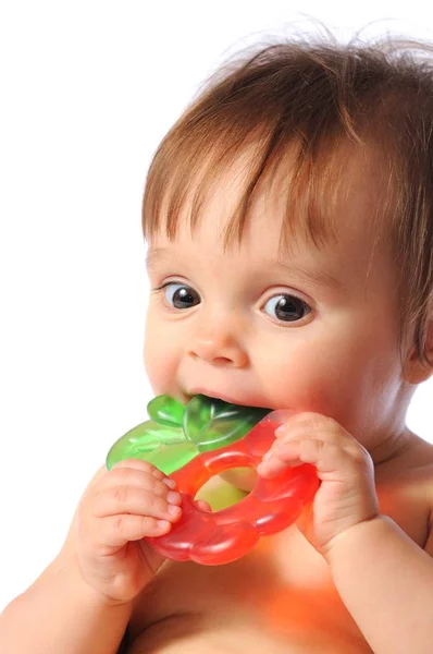 Little baby holds on hand teether, Baby bites teething toy — Stock Photo, Image