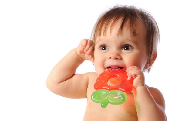 Little baby holds on hand teether, Baby bites teething toy — Stock Photo, Image