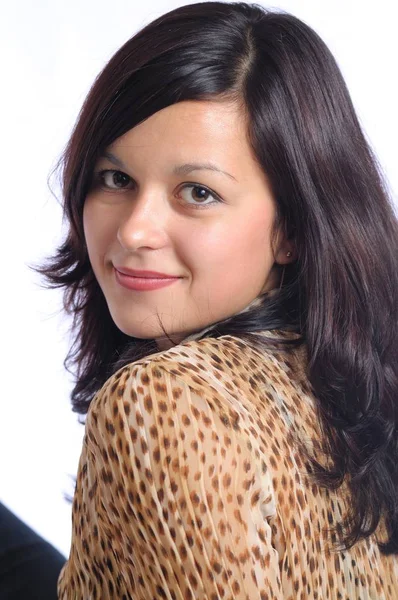 Brunette woman in leopard blouse looking at camera — Stock Photo, Image