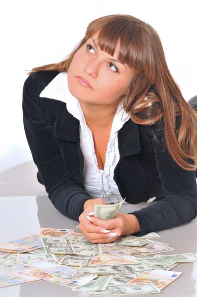 Woman lying near euro and dollar bills Royalty Free Stock Photos