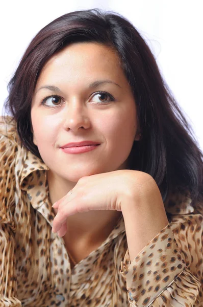 Brunette woman in leopard blouse looking at camera Stock Image