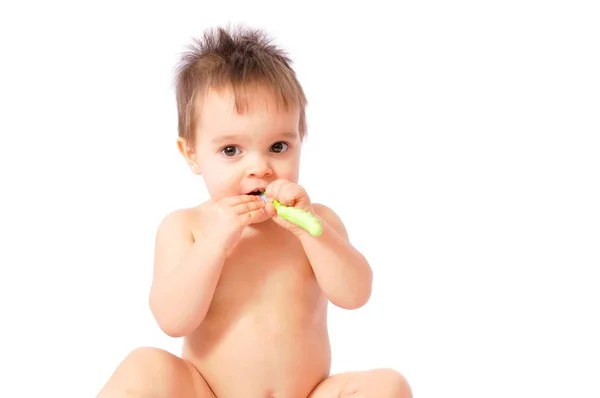 Baby girl holding her first green toothbrush — Stock Photo, Image