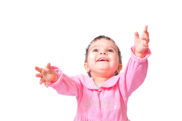 穿着粉红衣服的小女孩，手举着手坐着 — 图库照片