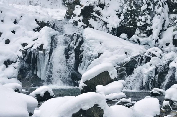 Beautiful snowy waterfall flowing in the mountains — Stock Photo, Image