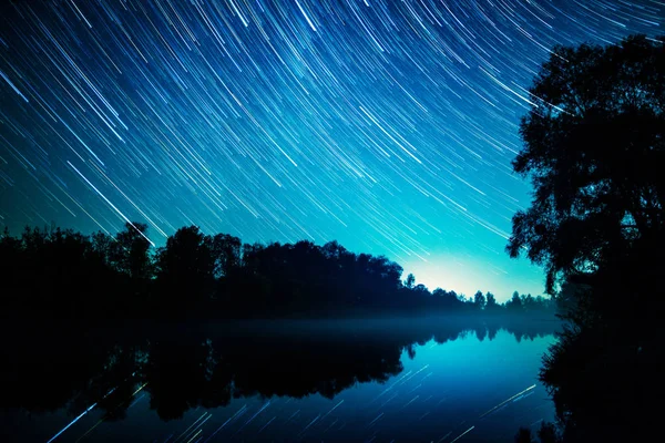 Star trails at the river side — Stock Photo, Image