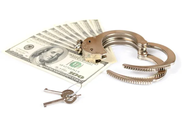 Otwórz metalowe kajdanki, klucze i stos amerykańskich dolarów gotówką — Zdjęcie stockowe