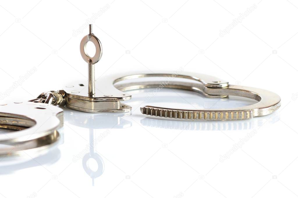 Close-up of a key opens a handcuff