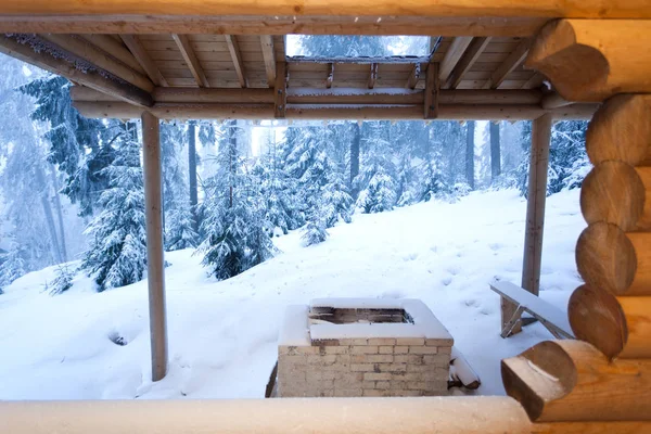 View to winter deep forest from wooden house entrance — Stock Photo, Image