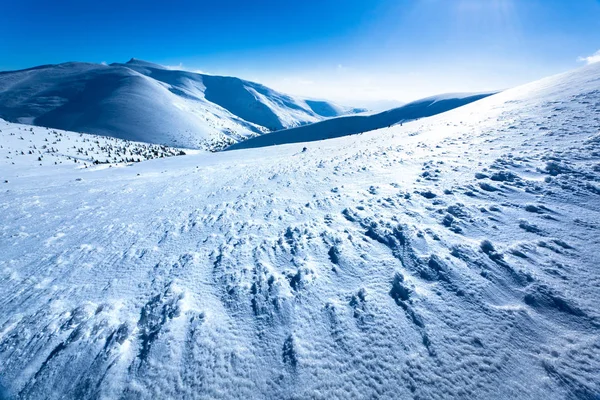 晴朗的日子里，雪地的冬季山谷被群山环抱着 — 图库照片