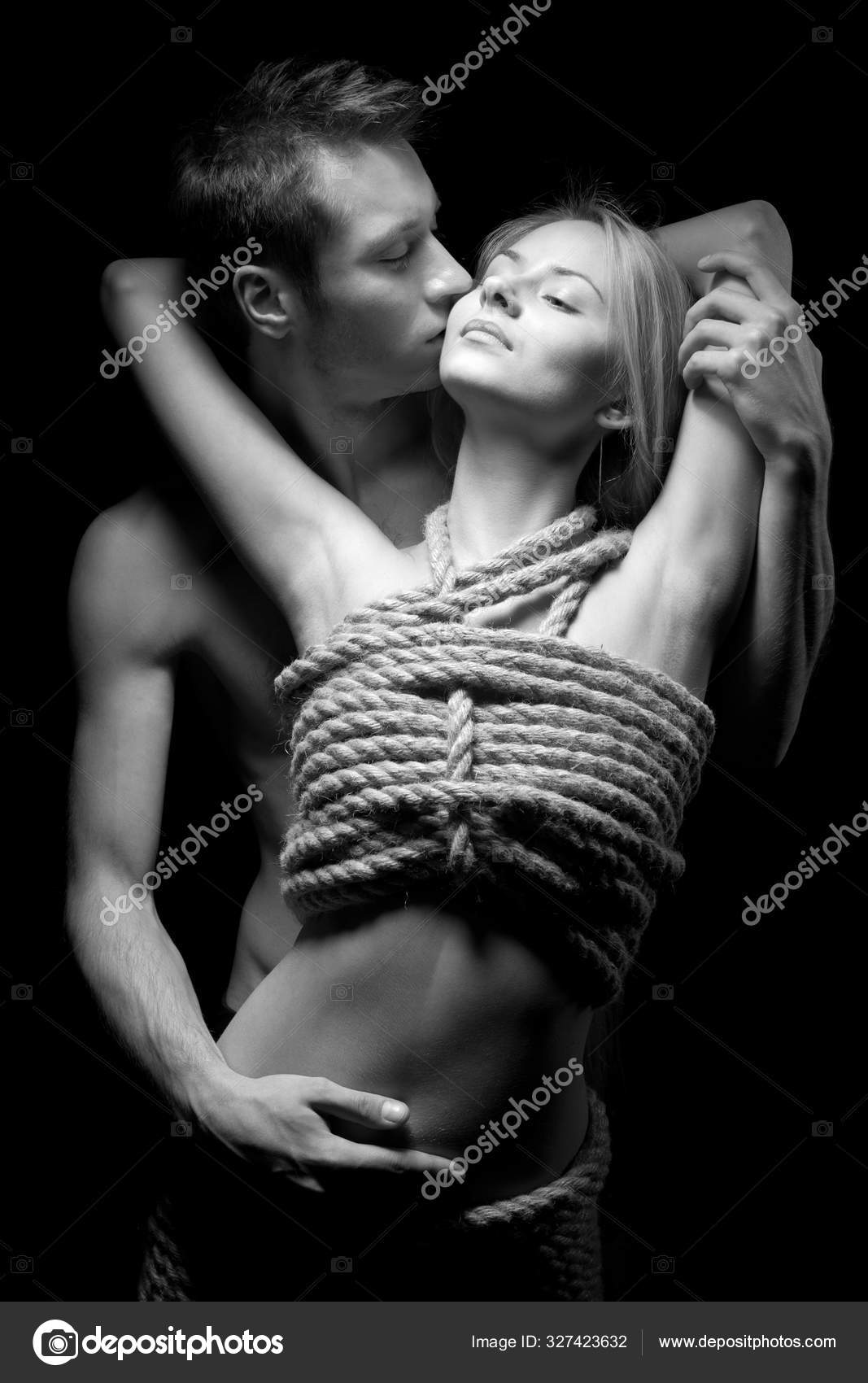 Man embracing and kissing his woman with naked body covered with ropes Stock Photo by ©YouraPechkin@gmail 327423632 image