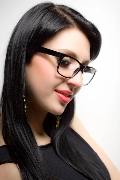 Young brunette womans face with extended lashes in glasses — Stock Photo, Image