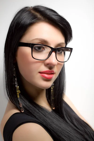 Young brunette woman in black clothing and glasses — Stock Photo, Image