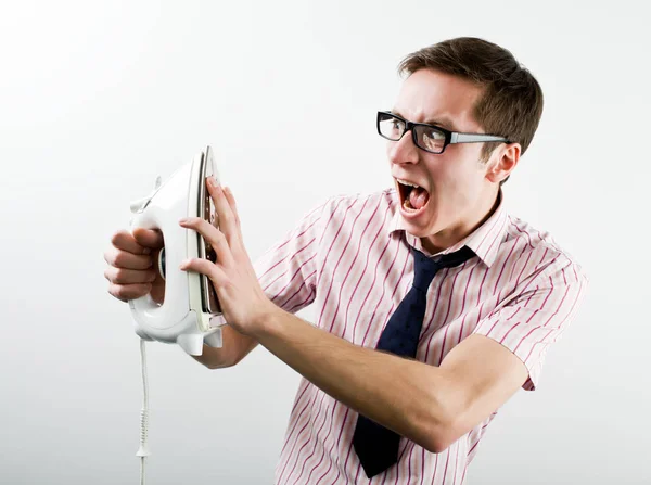 Young businessman feeling stressed touching hot iron — Stock Photo, Image
