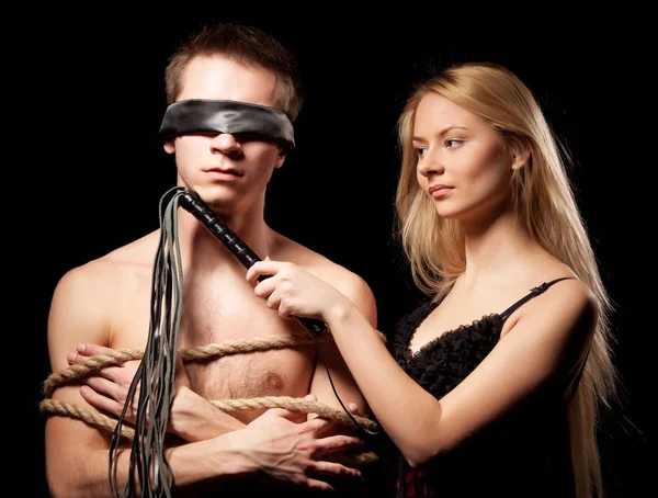 Young woman in wedding dress standing near naked man tied up with ropes — Stock Photo, Image