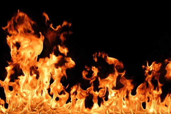 Abstract fire burns on dark background — Stock Photo, Image