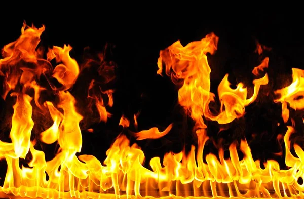 Abstract fire burns on dark background — Stock Photo, Image