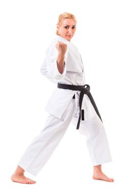Beyaz arka planda karate pozu veren kadın.