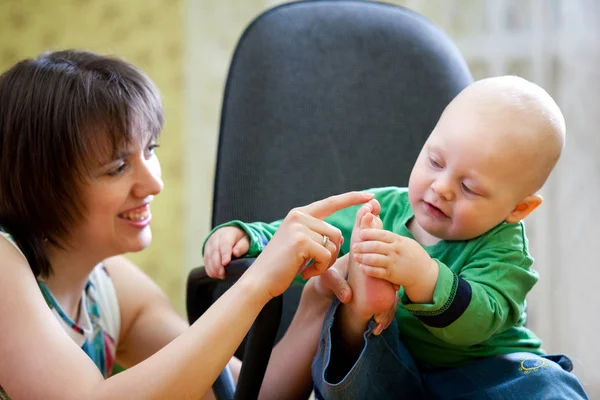 Little boy sits on computer chair — Stock Photo, Image