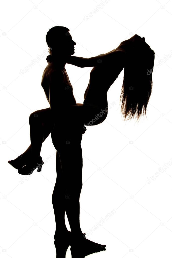 Silhouette of couple posing and hugging