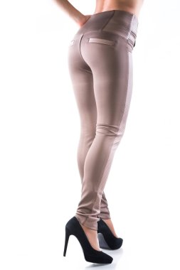 Deri, açık renk dar pantolonlu kadın kıyafeti.