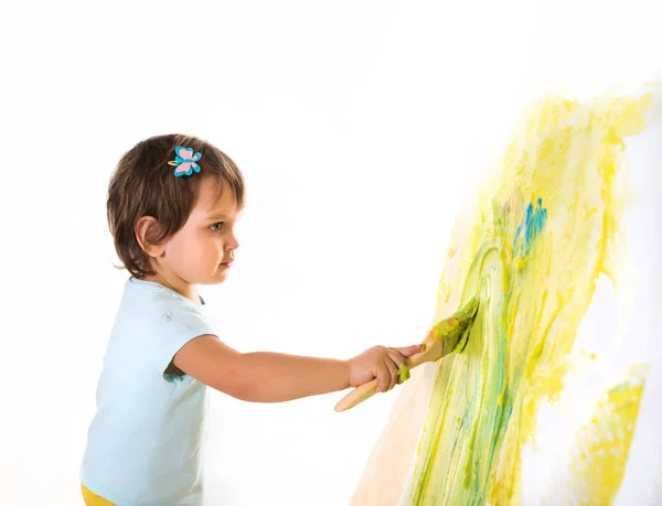 Little girl holds brush in hands and draws — 스톡 사진