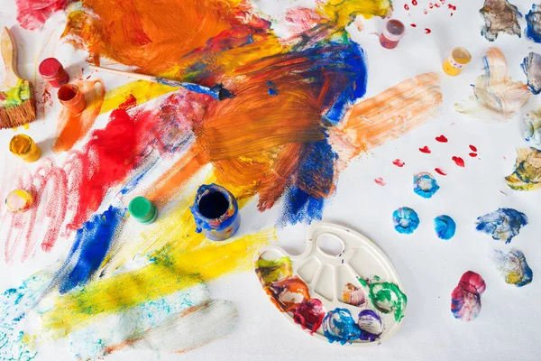 Children drawings with paints, brushes and palette
