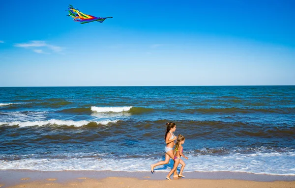 Two little happy cheerful girls run with a kite — Stock Photo, Image