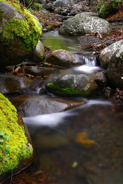 Strömma med vattenfall och mossiga stenar runt — Stockfoto