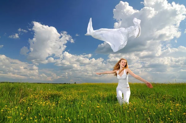 Woman posing in a green field with airiness silk — Stock Photo, Image