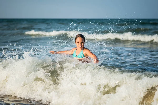 Feliz niña emocional se baña en las olas del mar — Foto de Stock