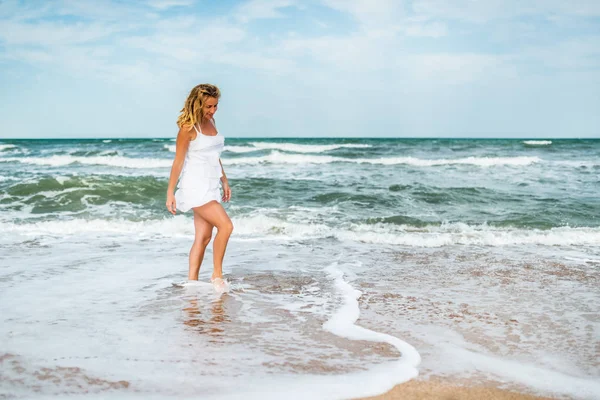 Charming young woman in a white dress — 스톡 사진