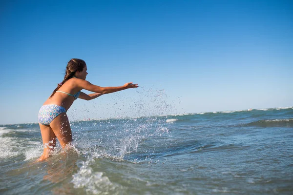 Little funny active girl splashing in noisy sea — 스톡 사진